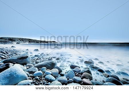 Background of water and rolling stones at Moelen