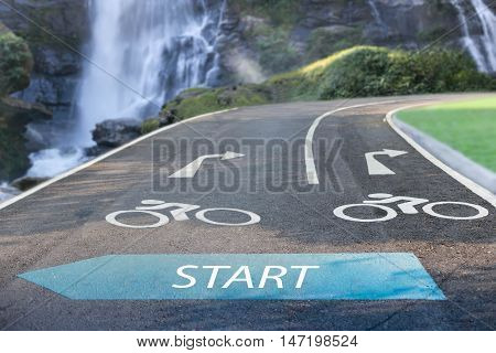 Focus on Road sign bicycle lane and waterfall in background