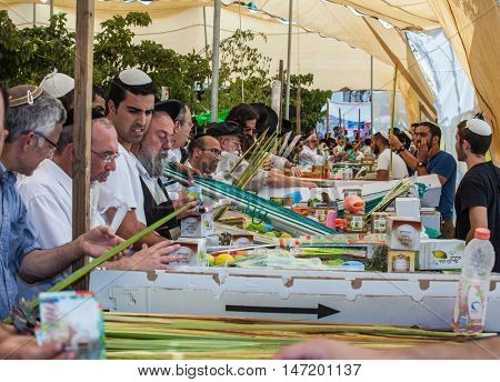 JERUSALEM, ISRAEL - OCTOBER 8, 2014: Sukkot in Israel. Religious Jews buy items, necessary during the holiday. Traditional holiday market in Jerusalem