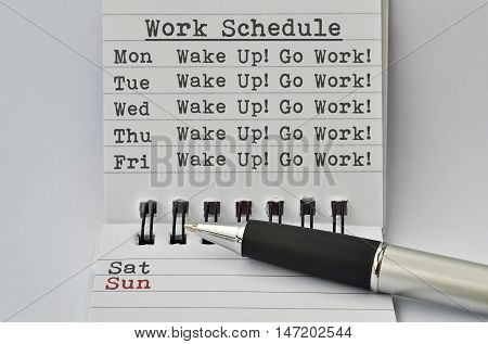 Text Work Schedule written on paper and a pen