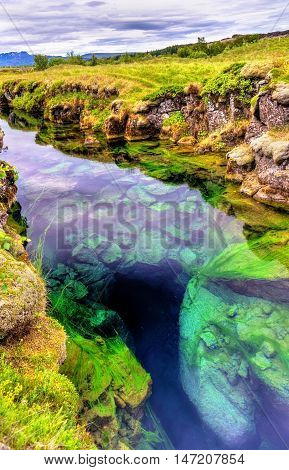 Water in a fissure between tectonic plates in the Thingvellir National Park - Iceland