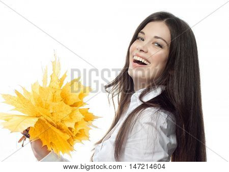 closeup portrait of attractive  caucasian smiling woman brunette isolated on white studio shot lips toothy smile face hair head and shoulders looking at camera hand holding yellow marple autumn leaves