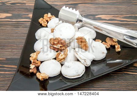 Air meringue with nuts on a white plate
