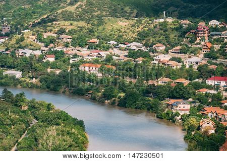 The Scenic Top View Of Mtskheta, Georgia. The Residential Area Along Bank Of The Aragvi River In Summer Sunny Day.
