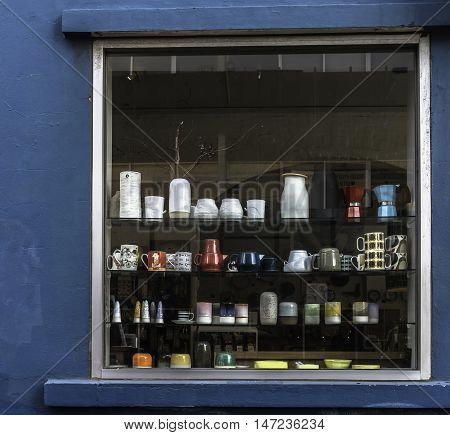 Window with shelves with assorted bric a brac set in a blue wall