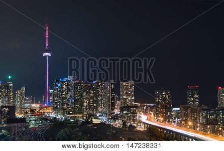 Glowing light streaks from Gardiner Expressway as traffic  never stops.  Hot & muggy summer night in Lakeside 
Toronto, Canada.