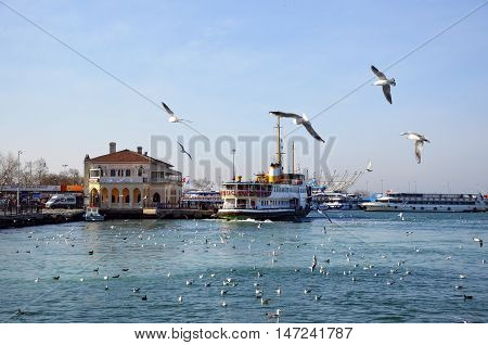 Istanbul Turkey - February 2 2014: Istanbul Ferries. Kadikoy pier and a flock of seagulls (called vapur in Turkish) continue to serve as a key public transport link for many Thousands of commuters tourists and vehicles per day.