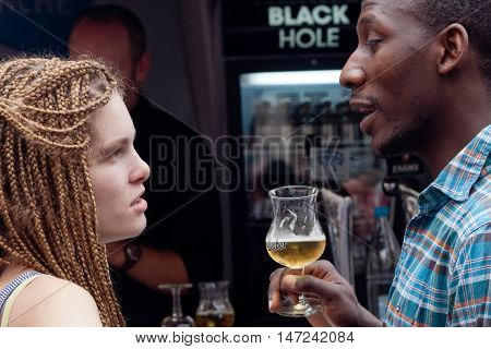 BELGIUM, BRUSSELS - SEPTEMBER 07, 2014: Belgian Beer Weekend 2014. The most famous beer festival in Belgium. A girl and a guy with a glass of beer at the festival.