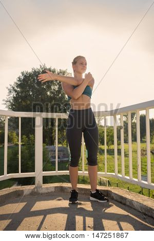 Teenage Girl Stretching Outdoors Arms Sunny Day