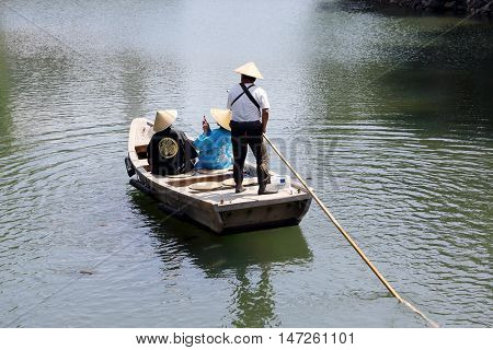 KAGAWA, JAPAN - JULY 20 2016: The small tourist ship of the pond of Tamamo Park Garden in Takamatu, Kagawa, Japan on July 20, 2016. Tourists are enjoying sightseeing.
