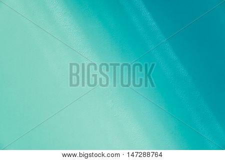 Cement wall texture with green turquoise color background.