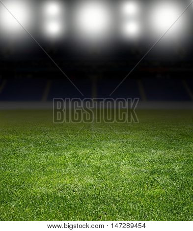 Green soccer field row of bright spotlights illuminated stadium in night