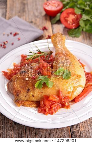 chicken leg cooked with tomato and herbs