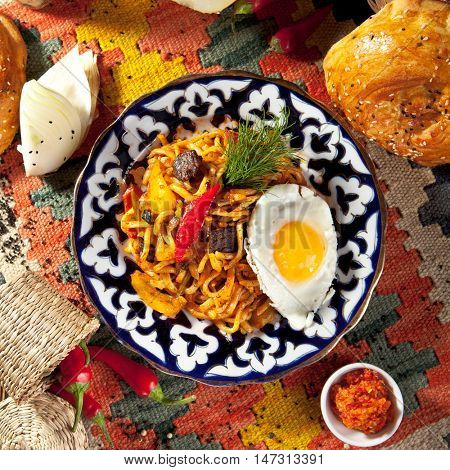 Asian Style Noodles with Meat and Laghman Sauce. Garnished with Fried Egg