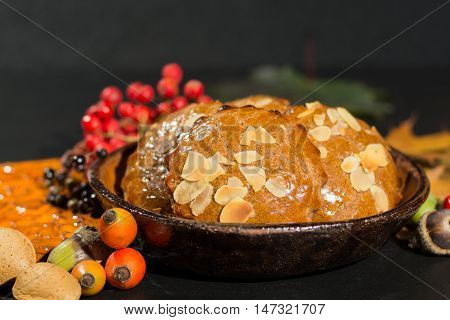 Typical Dutch filled spicy cookies with almonds on autumn colored and dark background