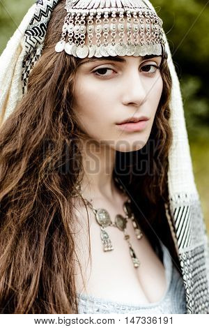 Young girl in traditional folk Crimean Tatar clothes walking in fields