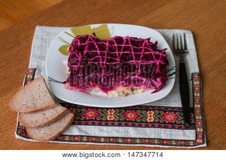 Dressed herring (Ukrainian: Shuba) is a layered salad composed of diced salted herring covered with layers of grated boiled vegetables (potatoes, carrots, beet roots), chopped onions, and mayonnaise.