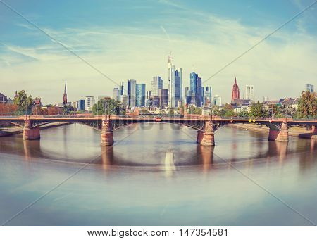 Daytime view of Frankfurt city skyline with Alte Brucke bridge. Creative wide angle effect