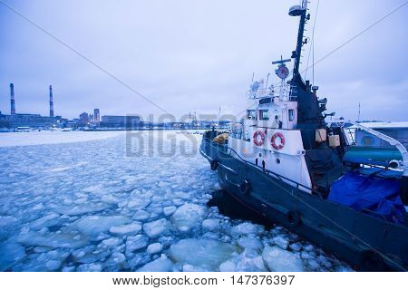 The Icebreaker Ship Trapped In Ice Tries To Break And Leave The Bay Between The Glaciers