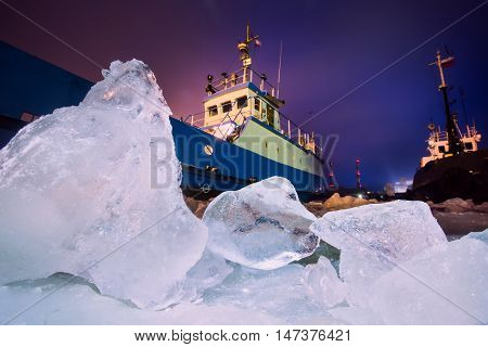 The Icebreaker Ship Trapped In Ice Tries To Break And Leave The Bay Between The Glaciers