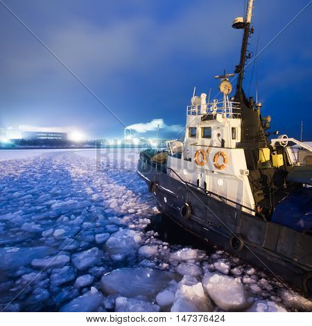 The Icebreaker Ship Trapped In Ice Tries To Break And Leave The Bay Between The Glaciers