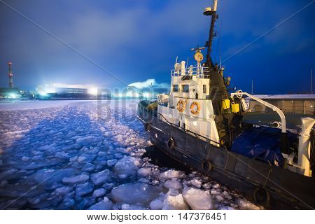 The Icebreaker Ship Trapped In Ice Tries To Break And Leave The Bay Between The Glaciers