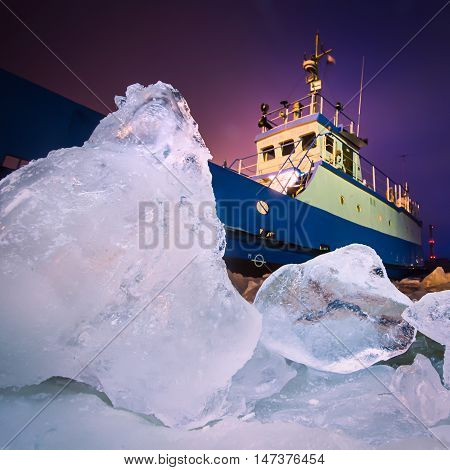 The Icebreaker Ship Trapped In Ice Tries To Break And Leave The Bay Between The Glaciers