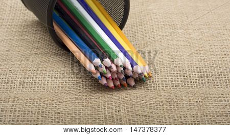 Colorful pencils coming out of holder close up.