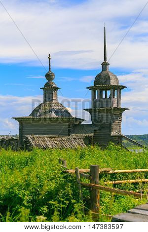 Old wooden Church in the village in the summer
