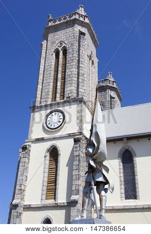 The tower of Saint Joseph's Cathedral with the statue of Joan of Arc next to (Noumea New Caledonia).