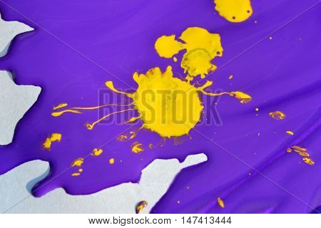 deliquescent yellow blotch on the purple paint on a white background
