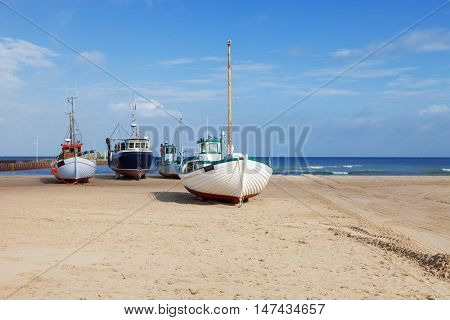 Fishing boats stranded on the beach at low tide