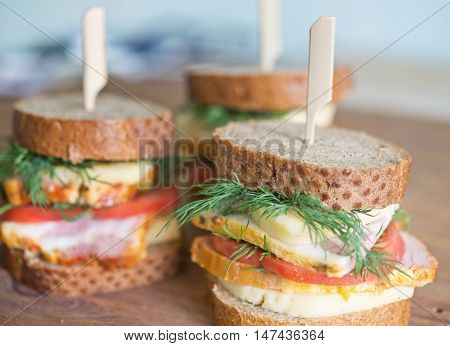 sandwiches with cheese carbonade tomato on a wooden table