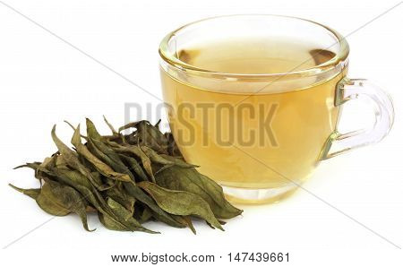 Ayurvedic medicinal Chirata with herbal juice in a glass