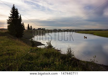 Rural landscape of small village Zamezhnaya near the river Pizhma