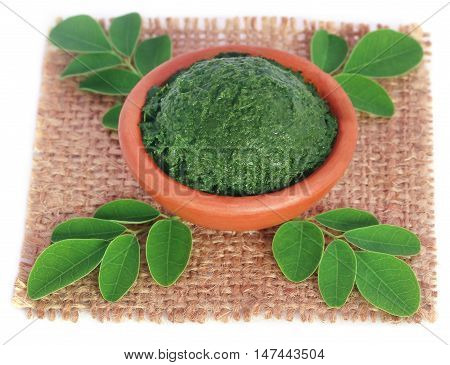 Edible moringa leaves with ground paste in a pottery