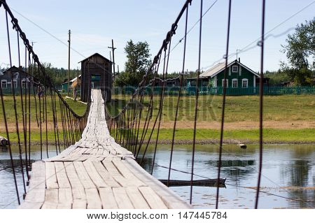Rural Landscape At Summer With Wooden Suspension Bridge