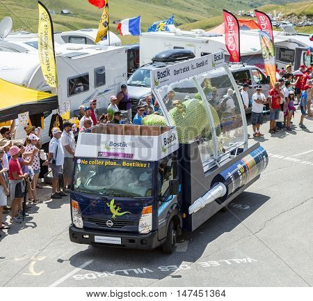 Col du Glandon France - July 23 2015: Bostik vehicle during the passing of the Publicity Caravan on Col du Glandon in Alps during the stage 18 of Le Tour de France 2015. Bostik is a leading global adhesive specialist in industrial manufacturing constructi