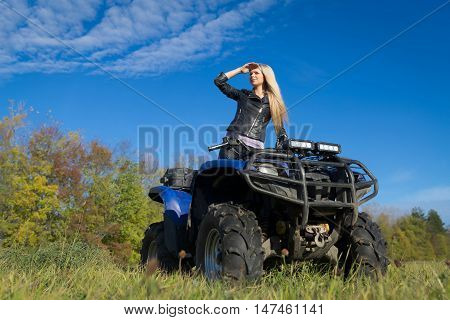 Elegant Blonde Woman Riding Extreme Quadrocycle Atv On Summer Field