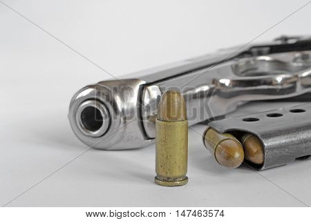 Pistol and ammunition on the white background.