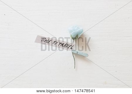 Tme to travel. Inscription and the beautiful blue flower.