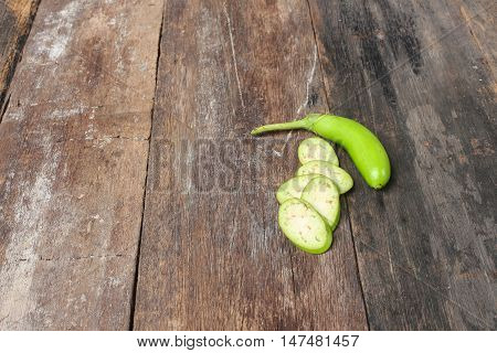Fresh Eggplants one cut in slices on a wooden. Summer fresh vegetables. (Solanum melongena)  and copy space.