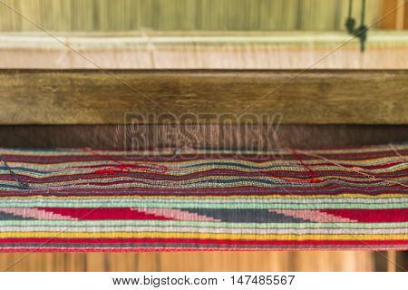 Weaving loom and shuttle on the warp.
