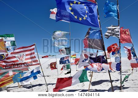 UYUNI BOLIVIA - August 28 2016. Flags of various nations in Salar de Uyuni Bolivia on August 28 2016. Salar de Uyuni is the worlds largest salt flat at 10582 square kilometres.
