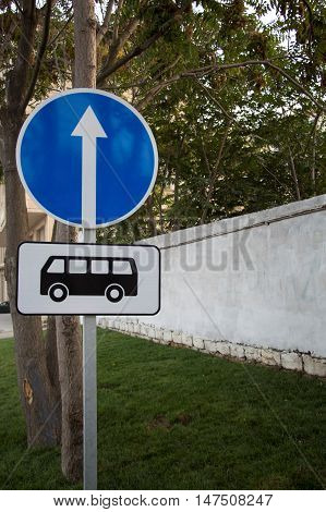 Bus stop road sign and Symbol straight ahead arrow. Information sign.
