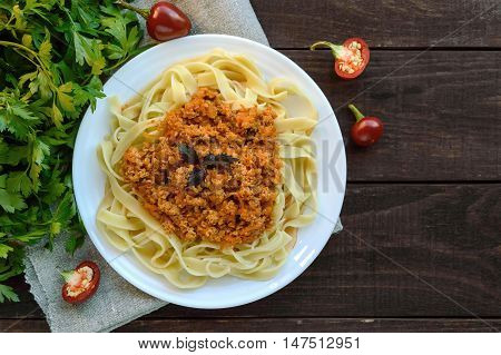 Pasta tagliatelle with meat sauce bolognese on a white plate. The traditional view of food.
