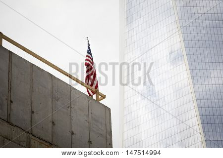 NEW YORK - SEPT 9 2016: American Flag displayed in the Liberty Park construction site near One World Trade Center building known as the Freedom Tower on the 15th anniversary of the terrorist attacks.