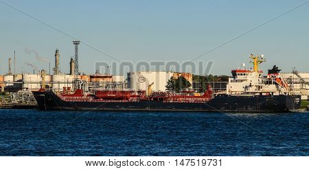 Sarnia, Ontario, Canada - September 12, 2016: The Great Lakes freighter Algonova at the Esso refinery in Sarnia, Ontario. Operating under Imperial Oil, it is the largest producer of petroleum products in Canada.