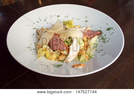 Delicious salad with chicken on the big plate