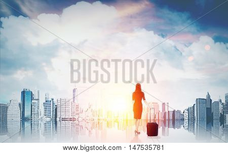 Woman with suitcase in front of magnificent city panorama at dawn. Concept of business prospects and international company job. Toned image.
